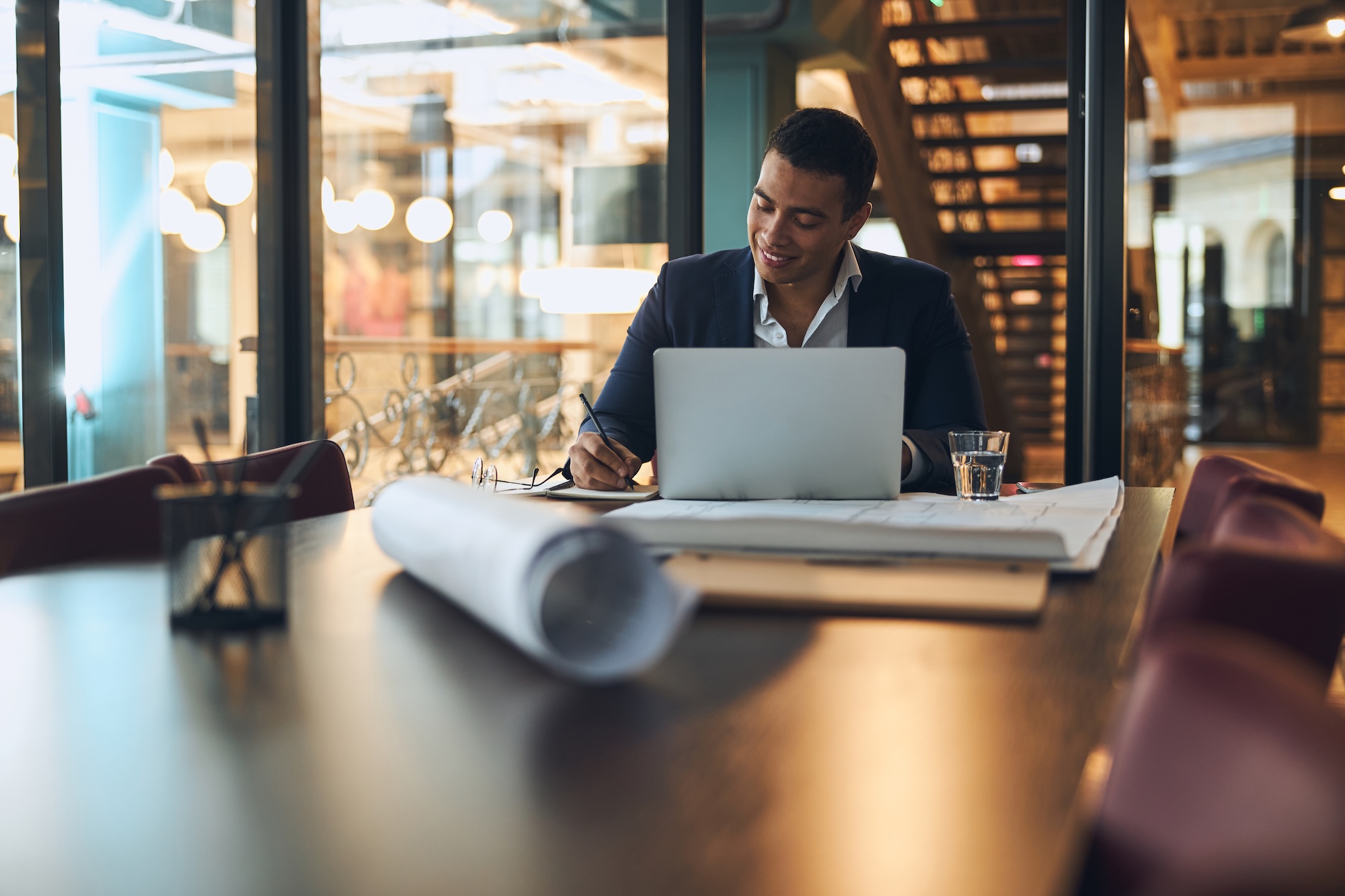joyful-latin-american-man-taking-notes-with-a-pen-2026-01-08-22-23-54-utc